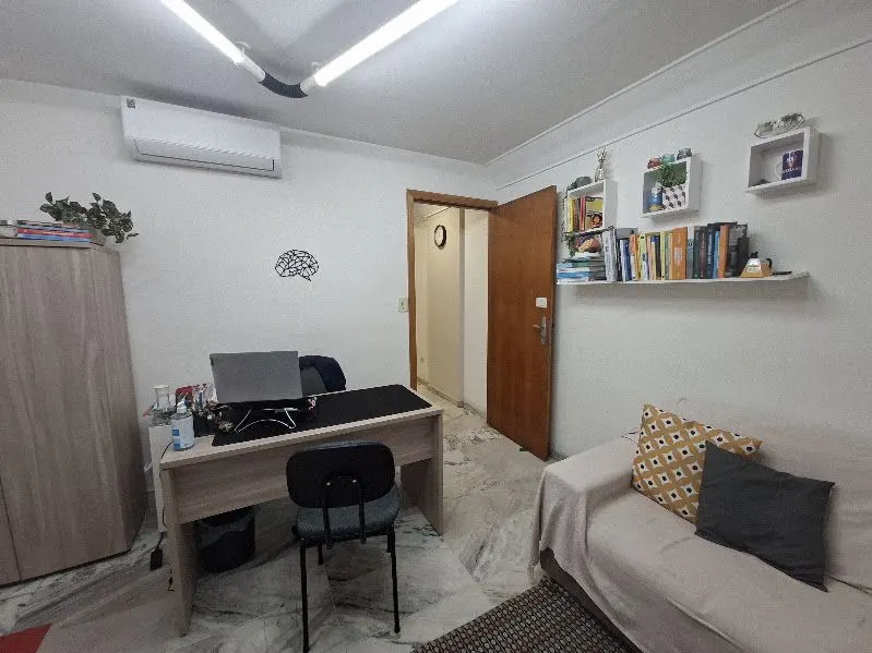 Sala 102, com mesa de atendimento e sofá.
